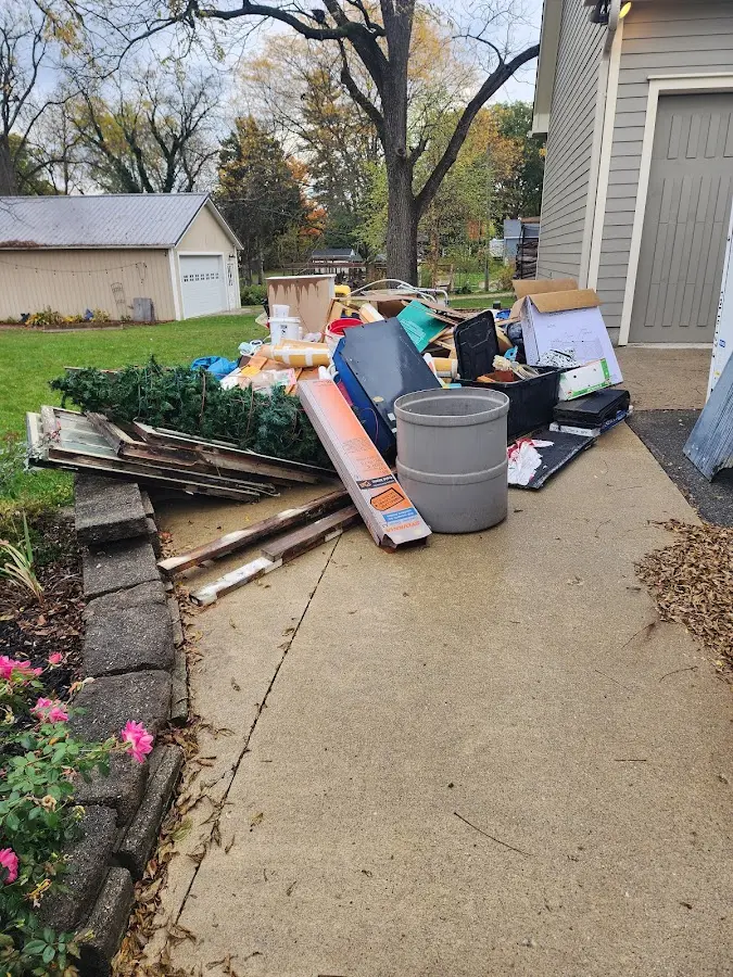 Dumpster being loaded with debris for 12 Yard Dumpster Rental in Temple Terrace